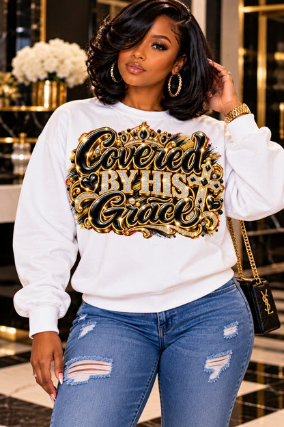 Covered by His Grace design in black and gold on a white sweatshirt, standing