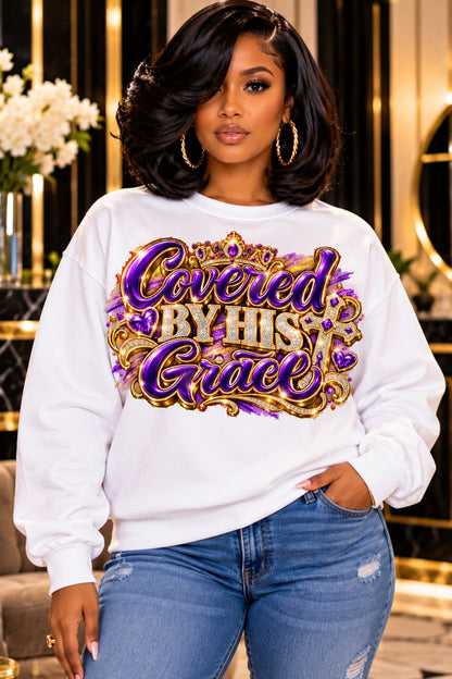 Covered by His Grace design in purple and gold on a white sweatshirt, standing