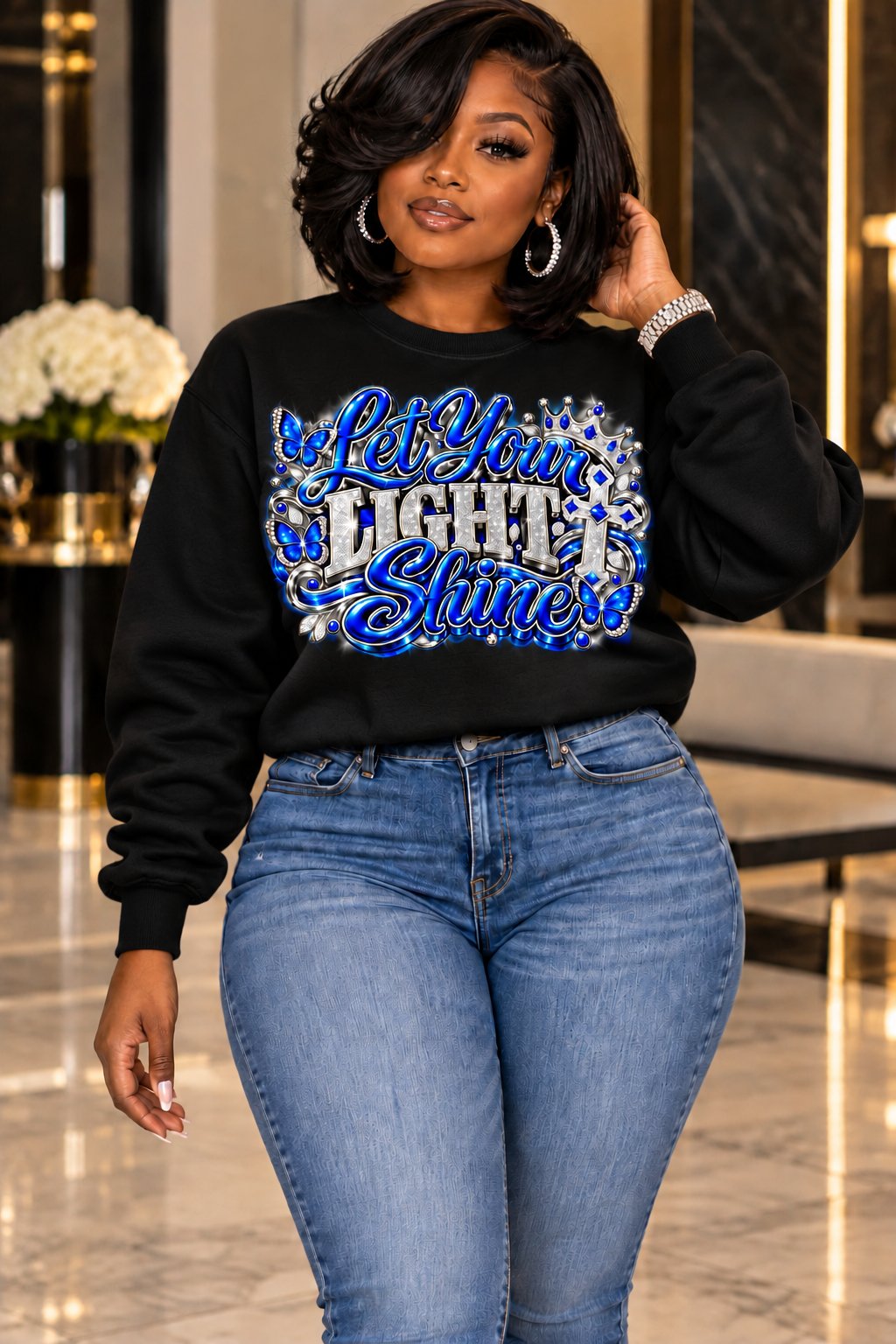 Let Your Light Shine design in blue and silver on a black sweatshirt, standing