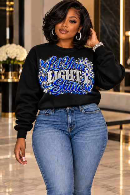 Let Your Light Shine design in blue and silver on a black sweatshirt, standing