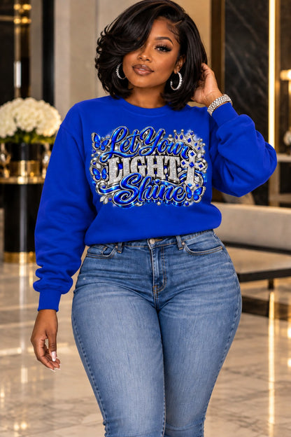 Let Your Light Shine design in blue and silver on a royal blue sweatshirt, standing