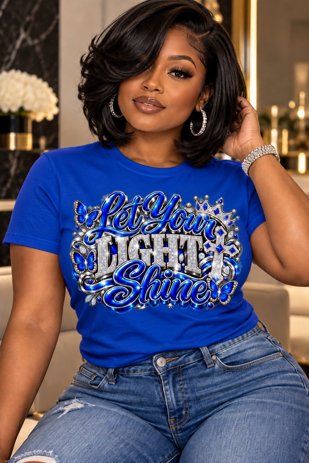 Let Your Light Shine design in blue and silver on a royal blue T-shirt, seated