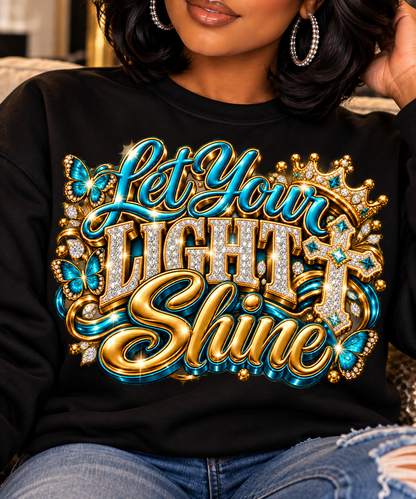 Let Your Light Shine design in turquoise and gold on a black sweatshirt, close-up