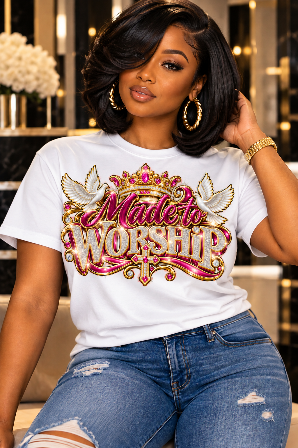 Made to Worship design in pink and gold on a white T-shirt, seated